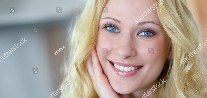 stock-photo-portrait-of-smiling-blond-woman-with-curly-hair-122349811