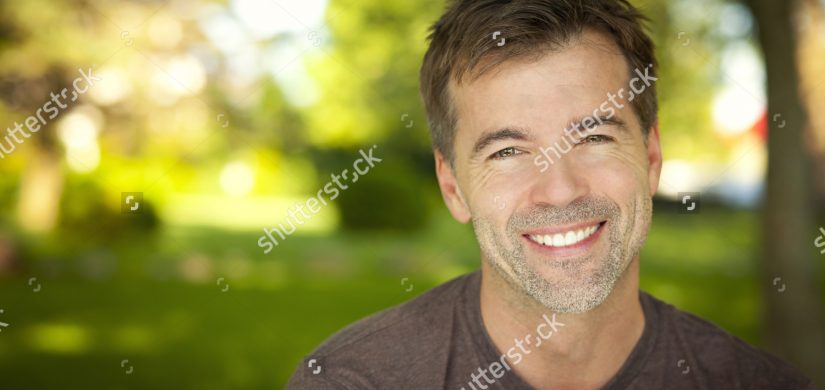 closeup-man-smiling-outside-150195365 closeup-man-smiling-outside-150195365