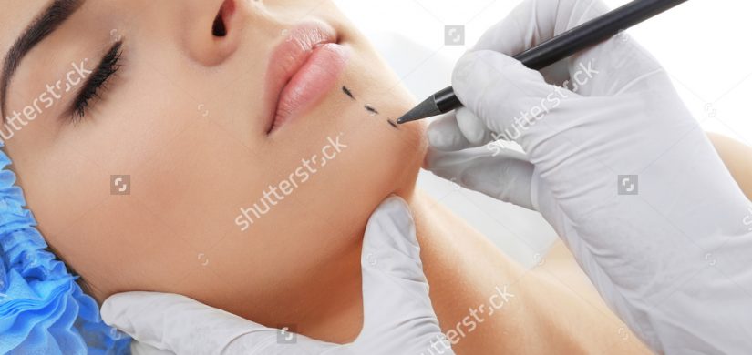 plastic-surgery-concept-hands-gloves-marking-511241416